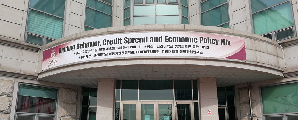 Korea UniversityにおけるセミナーBidding Behavior, Credit Spread and Economic Policy Mixで研究報告（会場建物と横断幕）